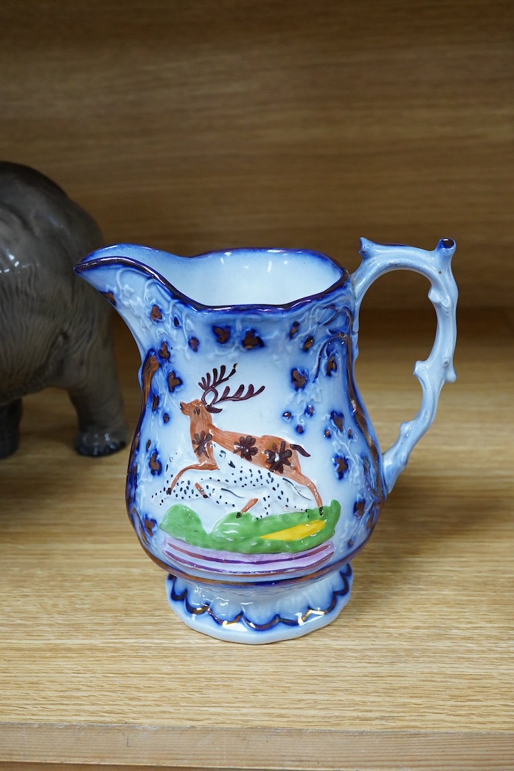 A Beswick model of an elephant and a Staffordshire jug, c.1840, largest 34cm wide